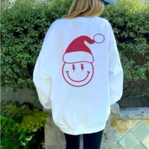 NWOT Gildan sweatshirt with Santa Smiley face on back. Never worn! Size M
